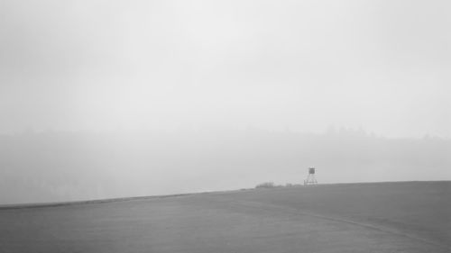 Scenic view of landscape against sky during foggy weather