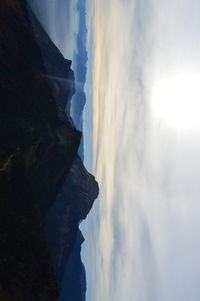 Scenic view of mountains against cloudy sky