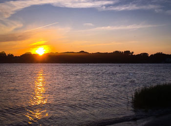 Scenic view of lake against romantic sky at sunset