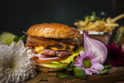 Close-up of burger on table against black background