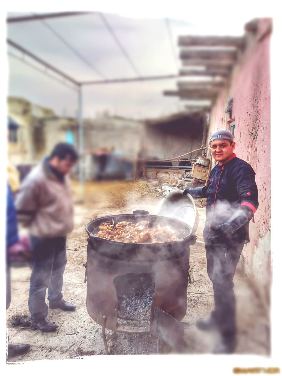 real people, men, two people, occupation, people, heat - temperature, preparation, food and drink, food, burning, smoke - physical structure, standing, working, day, full length, adult, looking at camera, nature, incidental people, preparing food, outdoors