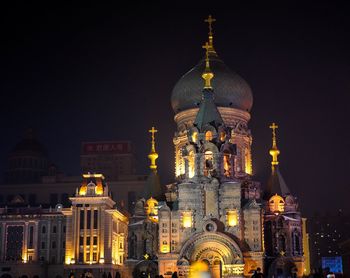 Illuminated cathedral against sky at night