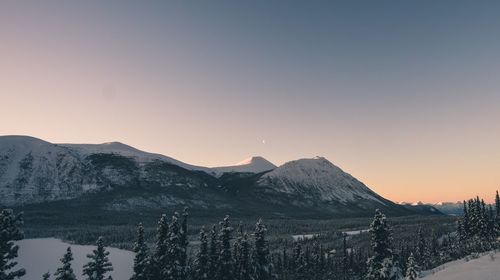 Scenic view of mountains against clear sky during winter