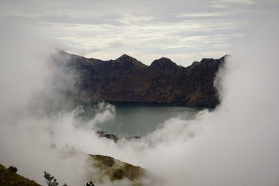 Scenic view of waterfall against sky