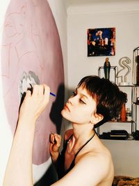 Portrait of woman holding hands at home