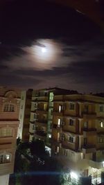 Illuminated cityscape against sky at night