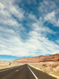 Empty road along countryside landscape