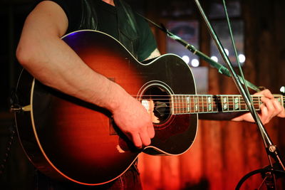 Cropped image of man playing guitar