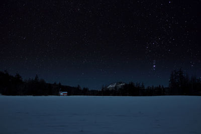 Orion nebula over snowy field