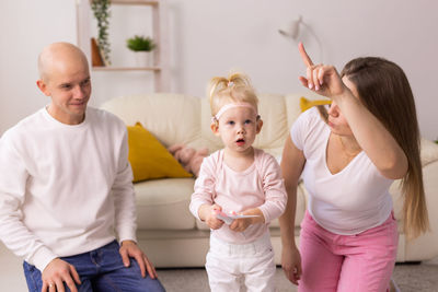 Portrait of happy family playing with toys at home