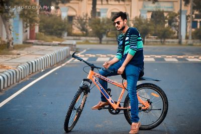 Man riding bicycle on street in city