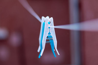 Close-up of clothespins hanging on clothesline