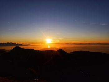 Scenic view of silhouette mountains against sky at sunset