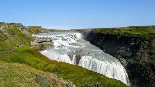 Scenic view of waterfall against clear sky