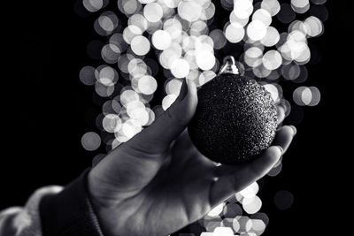 Close-up of hand holding christmas decoration