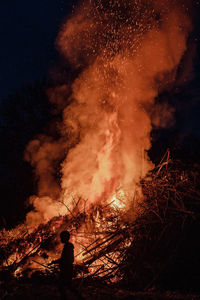 Rear view of man standing amidst smoke