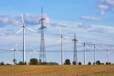 Wind turbines and power lines behind an acre seen in germany