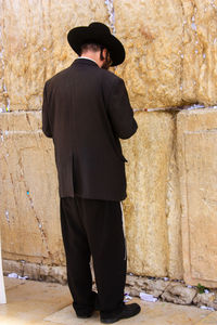 Men standing against built structure