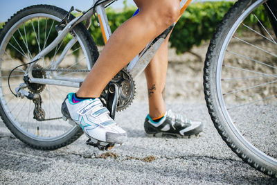 Close-up legs of female cyclist with cycling shoes