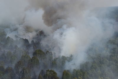 Smoke emitting from volcanic mountain against sky