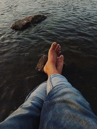 Low section of man relaxing in water