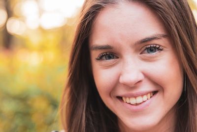 Close-up portrait of smiling young woman