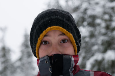 Portrait of person in knit hat during snowfall