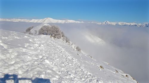 Scenic view of snowcapped mountains against sky