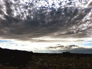 Silhouette landscape against sky