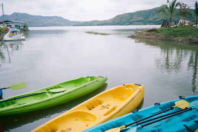 Boats moored in lake against sky