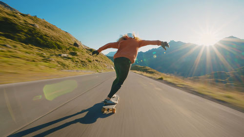 Full length of man jumping on road