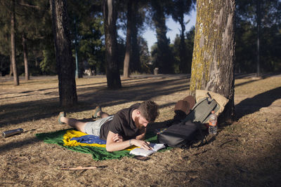 Man reading a book in a park