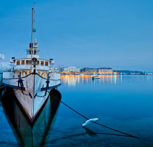 Boat moored in river against built structures