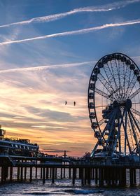 Two guys rappeling from ferrish wheel