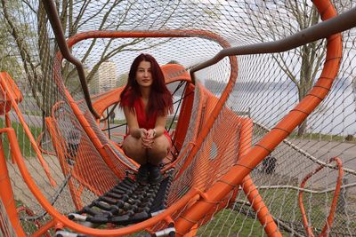 Portrait of smiling young woman in playground