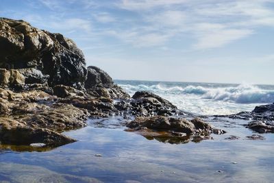 Scenic view of sea against cloudy sky