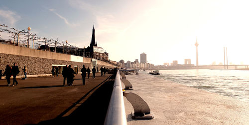 People walking on bridge in city