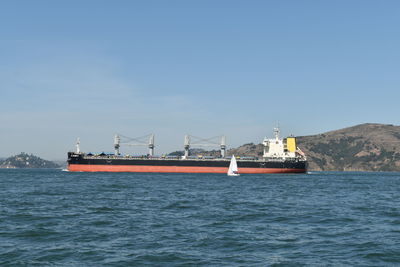 Ship sailing on sea against sky