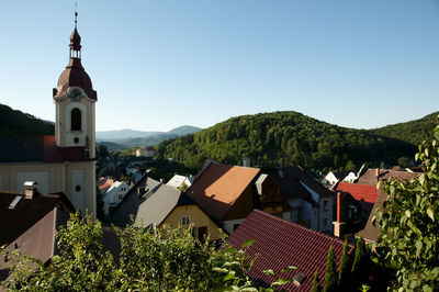 Houses in town against clear sky