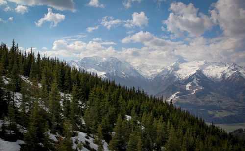 Scenic view of mountains against cloudy sky