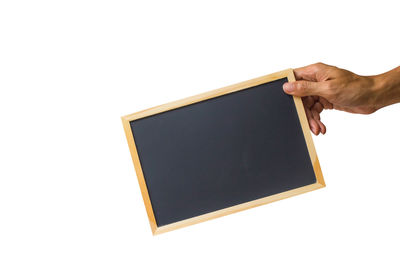 Low angle view of hand holding umbrella against white background