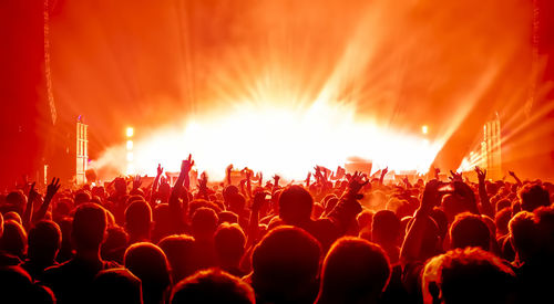 Crowd at music concert against sky