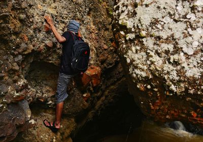 Full length of woman standing on rock formation