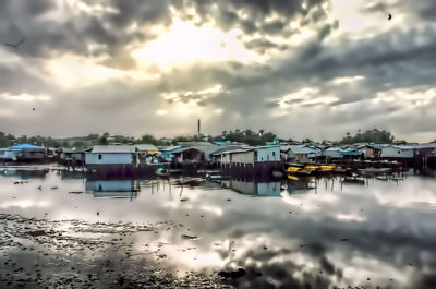 Buildings against cloudy sky