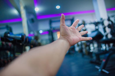 Cropped image of person hand on illuminated stage