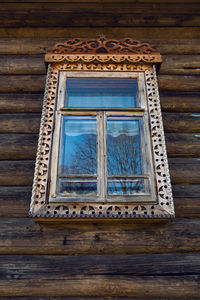 Window with glass in old log dark house