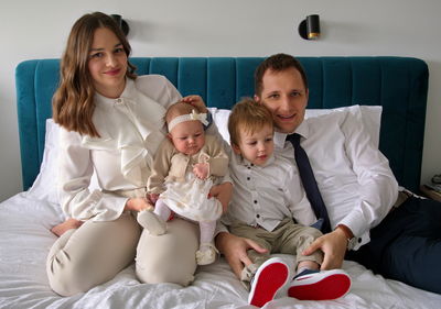 Young family celebrating christening of little baby girl