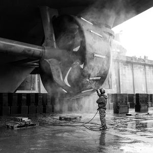 Man washing boat propeller