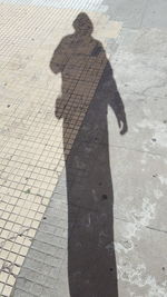 Shadow of man on cobblestone