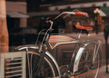 Close-up of bicycle parked on street in city